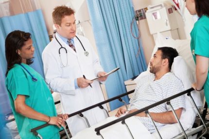 Clinicians with patient at bedside